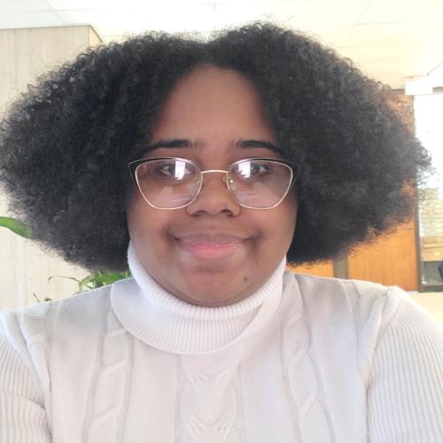 headshot of woman in white sweater