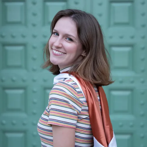 woman in front of teal wall