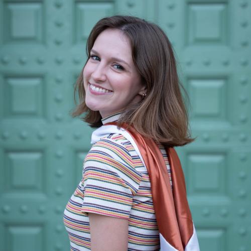 woman in front of teal wall